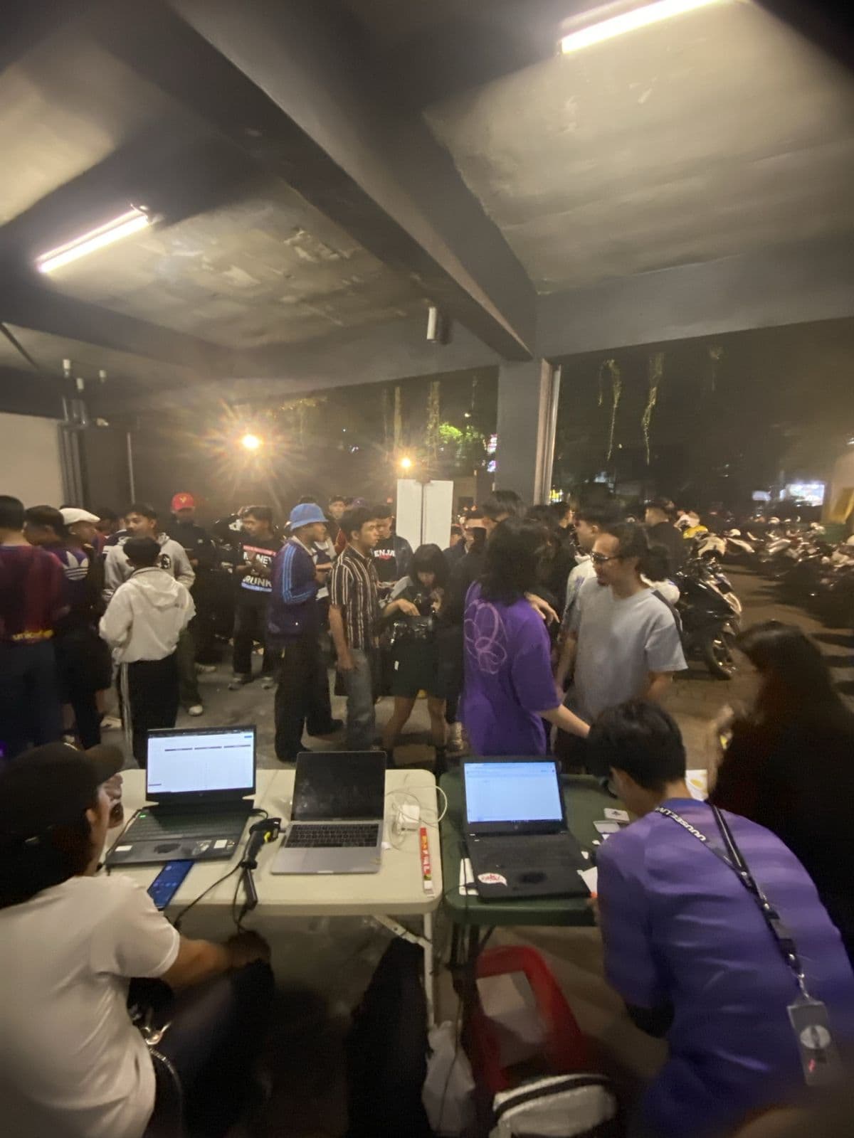 Outdoor check-in tables handling a large crowd